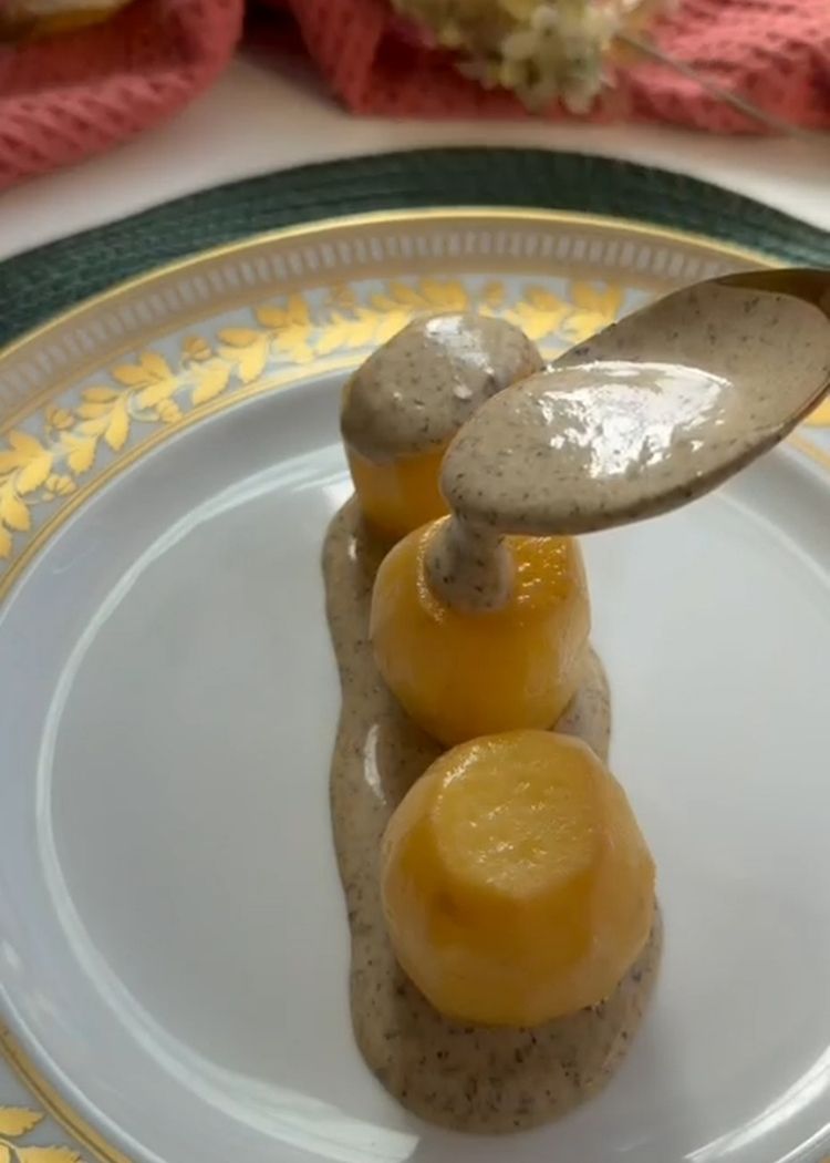 Servir Patatas confitadas con crema de yema y trufa
